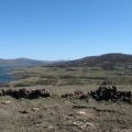 Ruined dry stone wall crossing summit of Gometra