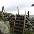 Stile and signpost, summit of Lee Pen