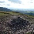 Summit cairn on Twmpa with views towards the Brecon Beacons