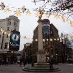 View of Christmas stars around the column with the six sundials in Seven Dials