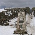 Whernside trig point and stile in the snow